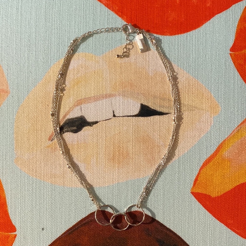 Silver multi-strand necklace with unity circles.